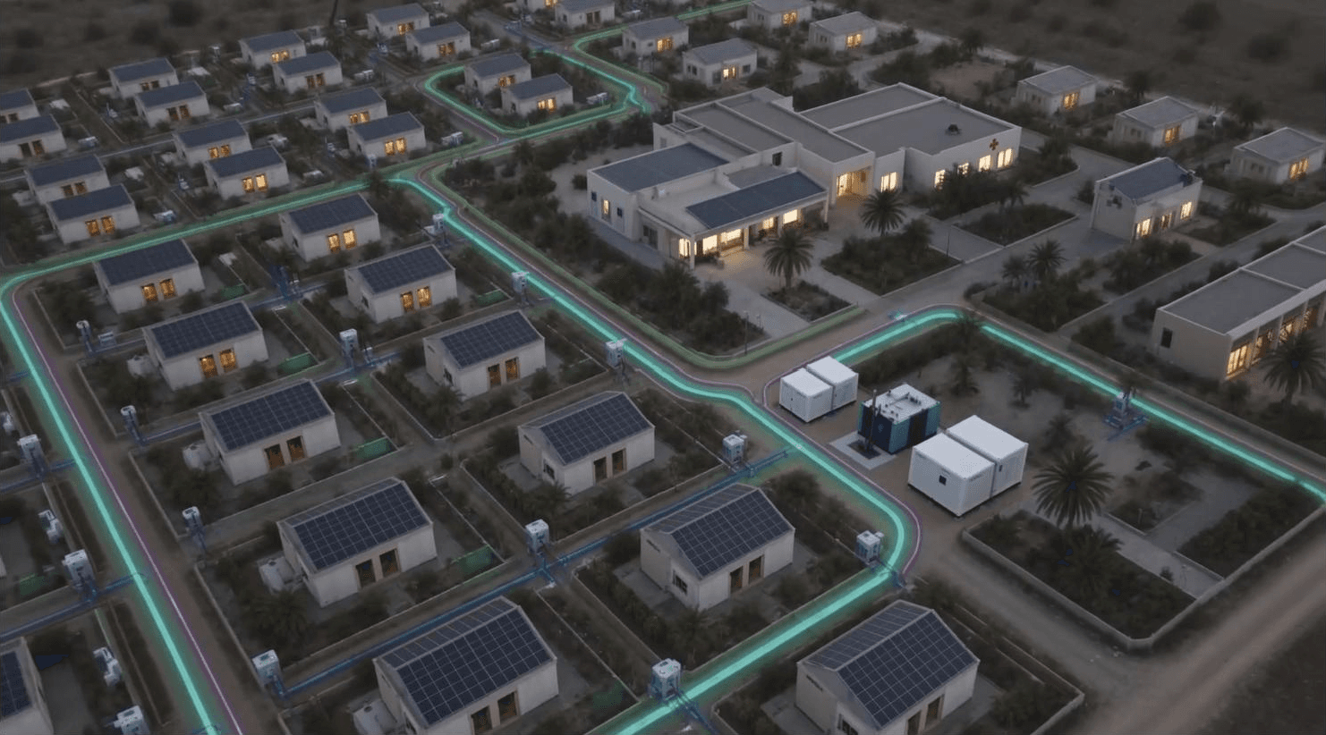 An aerial view of a single-story neighborhood at dusk, solar panels on every roof and lit water, power, sewage and reclaimed-water lines running between the houses to a pad of white INFRABOX containers, illustrative